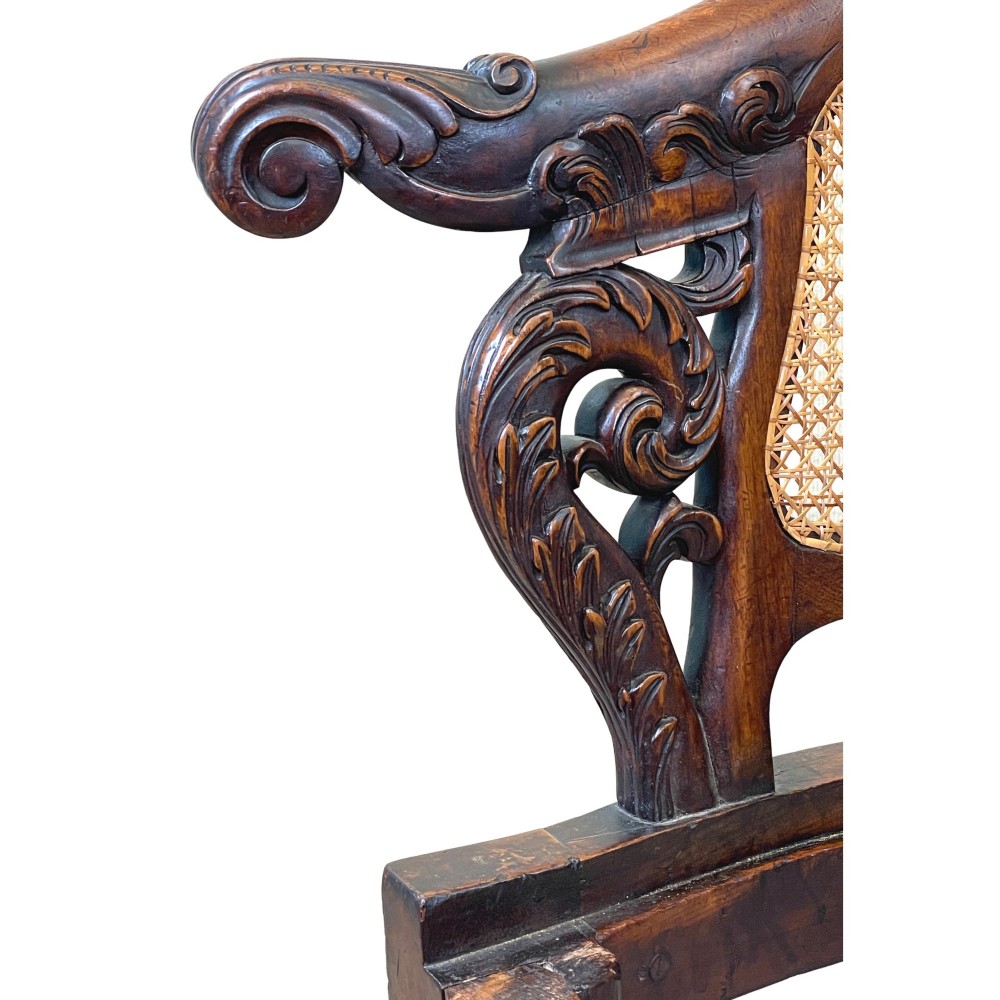 A 19th-century mahogany Burgermeister desk chair featuring a curved backrest with woven cane panels, carved armrests, an upholstered cream seat, and cabriole legs. View V