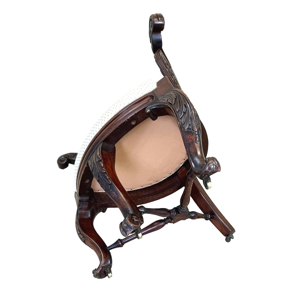 A 19th-century mahogany Burgermeister desk chair featuring a curved backrest with woven cane panels, carved armrests, an upholstered cream seat, and cabriole legs. View X