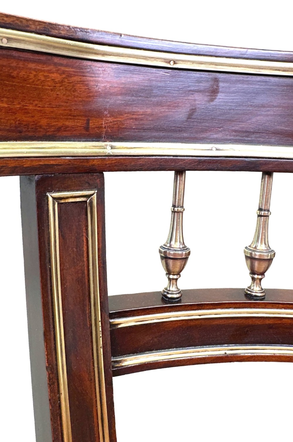 A pair of 19th-century French mahogany curved-back salon chairs with brass mounts, spindle details, woven cane seats, and turned front legs. View VII