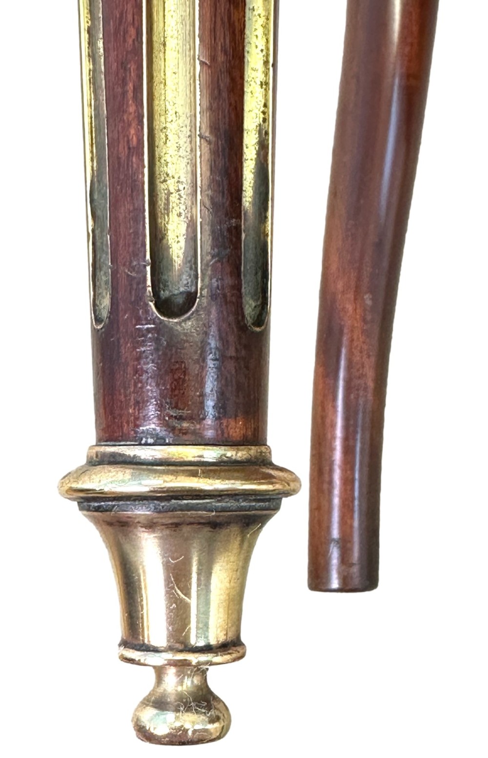 A pair of 19th-century French mahogany curved-back salon chairs with brass mounts, spindle details, woven cane seats, and turned front legs. View IX