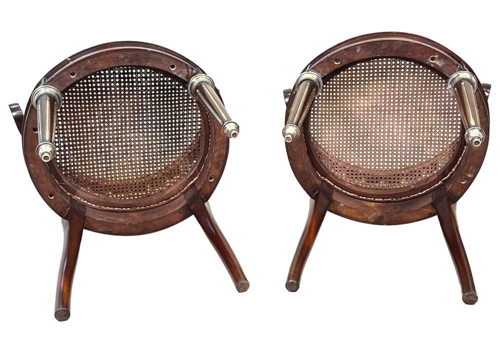 A pair of 19th-century French mahogany curved-back salon chairs with brass mounts, spindle details, woven cane seats, and turned front legs. View XIV