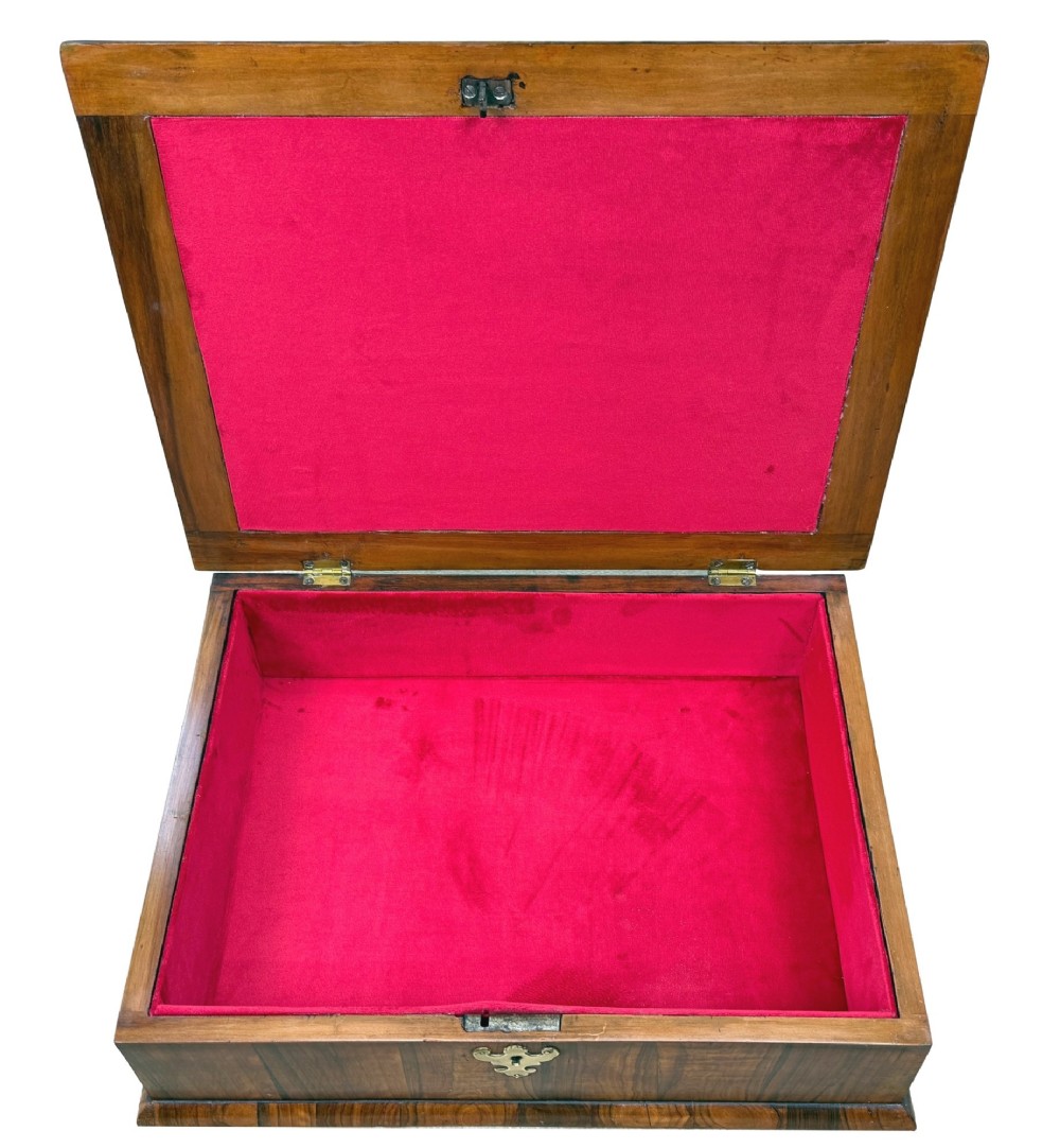 A shallow rectangular William and Mary period wooden box with laburnum oyster veneered patterns, concentric circular stringing on the lid, and a brass keyhole escutcheon on the front panel. View IV