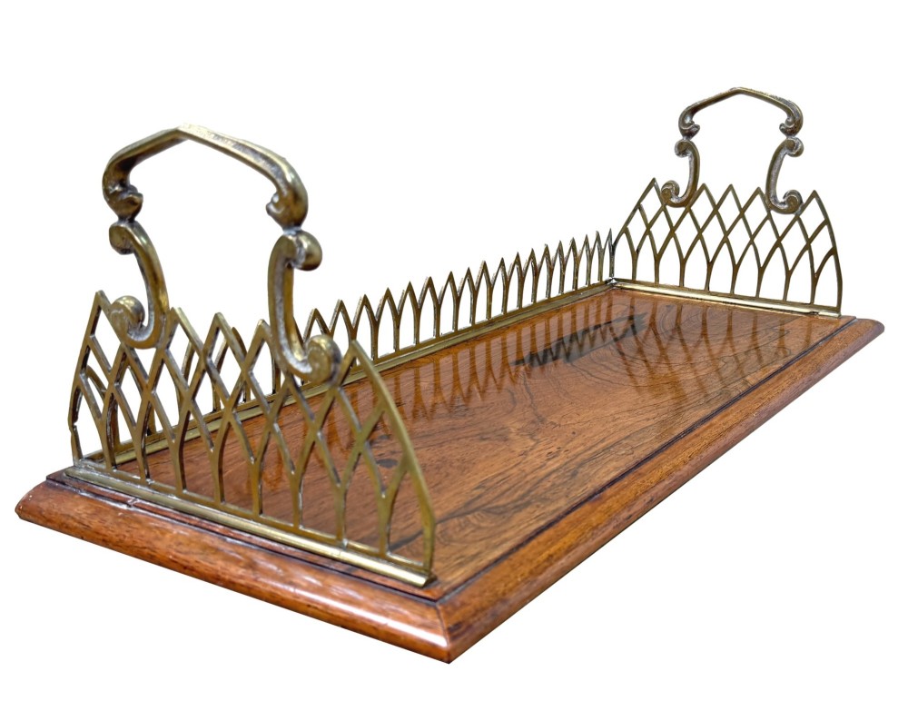A rectangular rosewood desk tray with a polished grain surface, featuring decorative pointed brass gallery borders and arched carrying handles at each end. View III