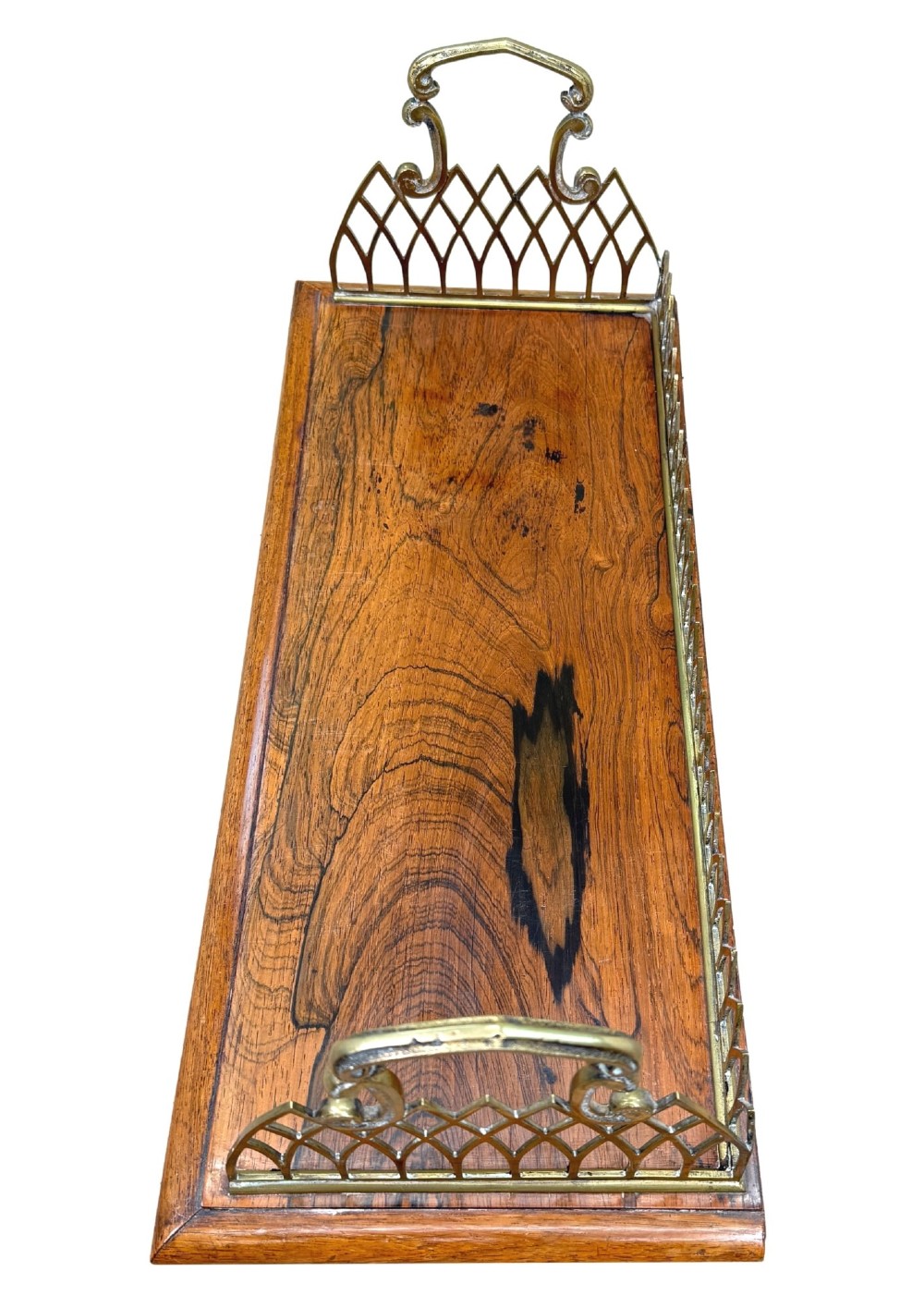 A rectangular rosewood desk tray with a polished grain surface, featuring decorative pointed brass gallery borders and arched carrying handles at each end. View V