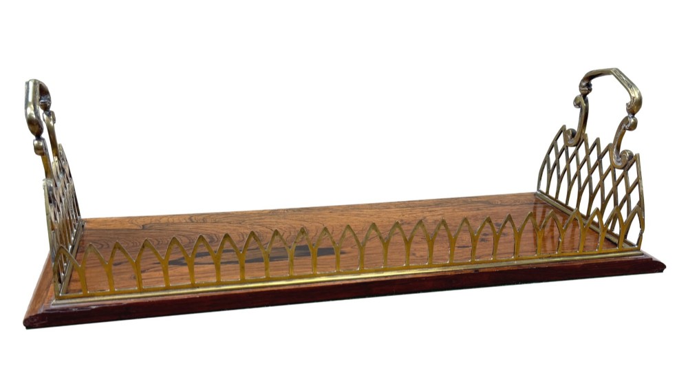 A rectangular rosewood desk tray with a polished grain surface, featuring decorative pointed brass gallery borders and arched carrying handles at each end. View VI