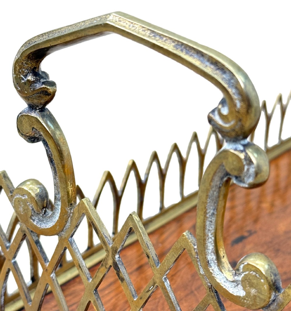 A rectangular rosewood desk tray with a polished grain surface, featuring decorative pointed brass gallery borders and arched carrying handles at each end. View VII