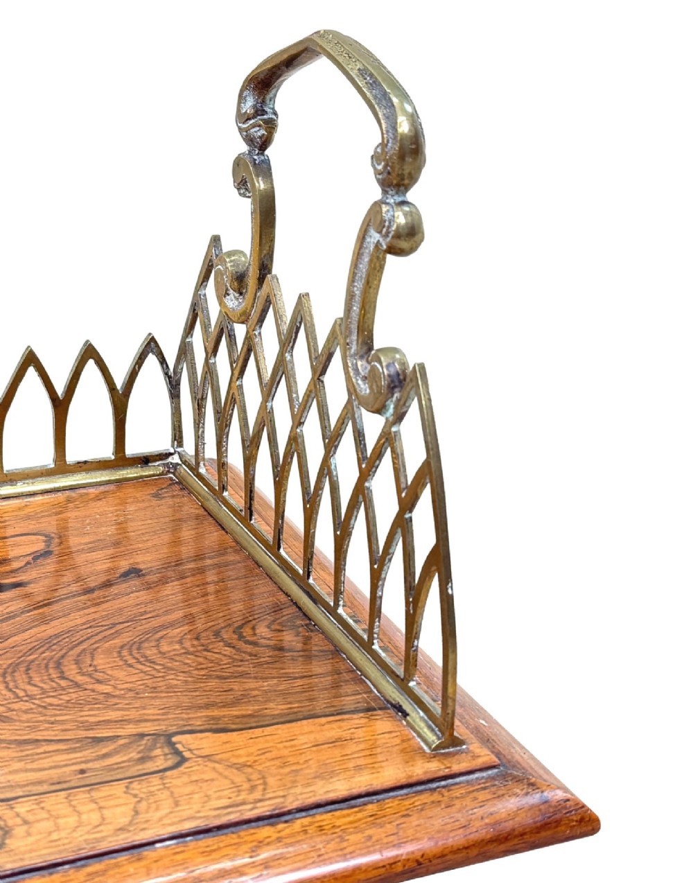 A rectangular rosewood desk tray with a polished grain surface, featuring decorative pointed brass gallery borders and arched carrying handles at each end. View IX