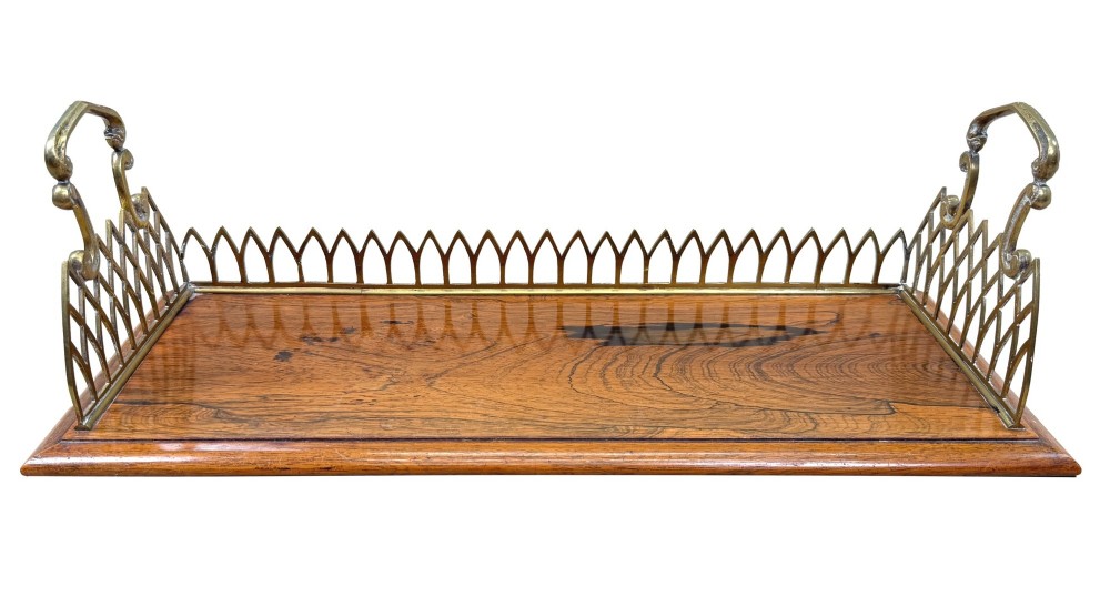 A rectangular rosewood desk tray with a polished grain surface, featuring decorative pointed brass gallery borders and arched carrying handles at each end. View XI
