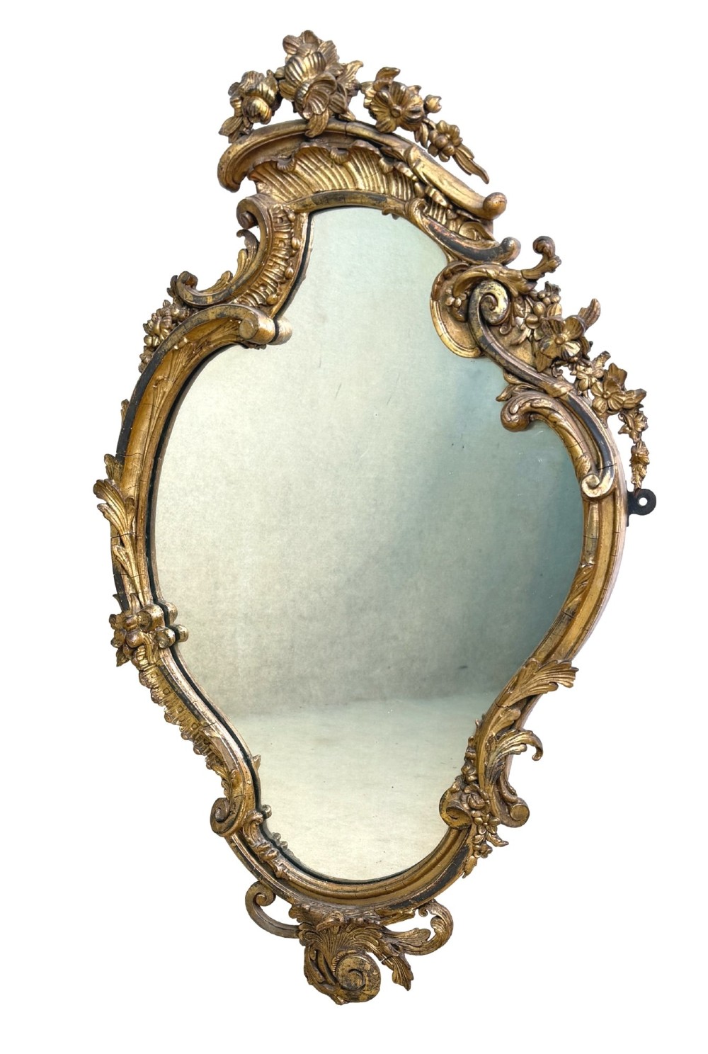 A pair of mid-19th-century cartouche-form wall mirrors featuring ornate carved giltwood and gesso frames decorated with scrolling foliage and floral cresting. View III
