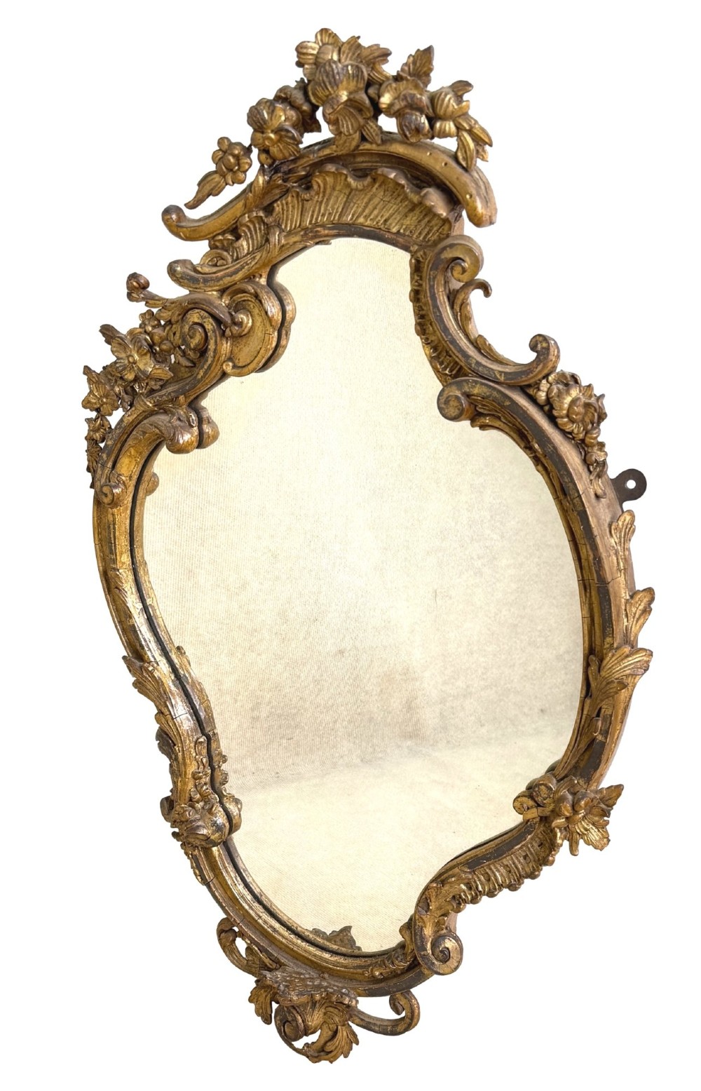 A pair of mid-19th-century cartouche-form wall mirrors featuring ornate carved giltwood and gesso frames decorated with scrolling foliage and floral cresting. View V