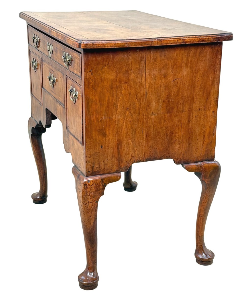 An early 18th-century George I walnut lowboy with four drawers, brass drop handles, a shaped apron, and cabriole legs with pad feet. View II