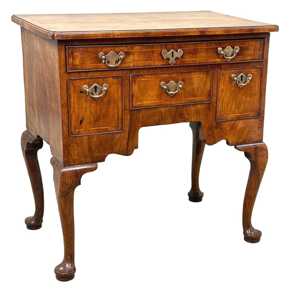 An early 18th-century George I walnut lowboy with four drawers, brass drop handles, a shaped apron, and cabriole legs with pad feet. View X