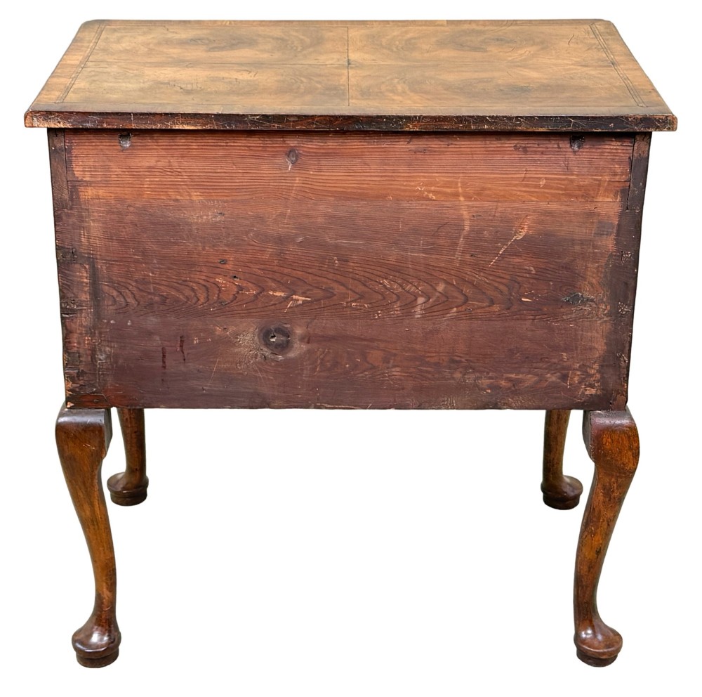 An early 18th-century George I walnut lowboy with four drawers, brass drop handles, a shaped apron, and cabriole legs with pad feet. View XI