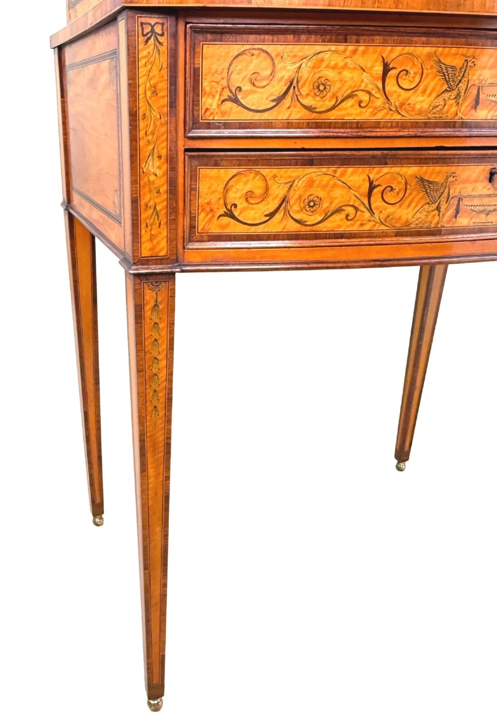 A 19th-century inlaid satinwood display cabinet featuring an arched cresting, glazed upper doors, marquetry frieze drawers, and square tapered legs. View X