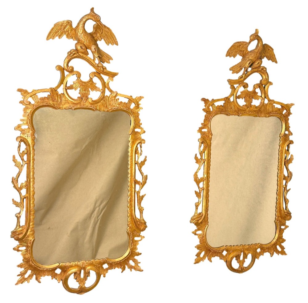 A pair of 18th-century Chippendale style giltwood wall mirrors featuring carved Rococo scroll frames topped with bird crests. View II