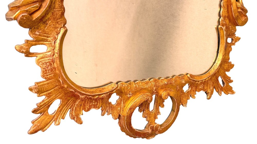 A pair of 18th-century Chippendale style giltwood wall mirrors featuring carved Rococo scroll frames topped with bird crests. View VI