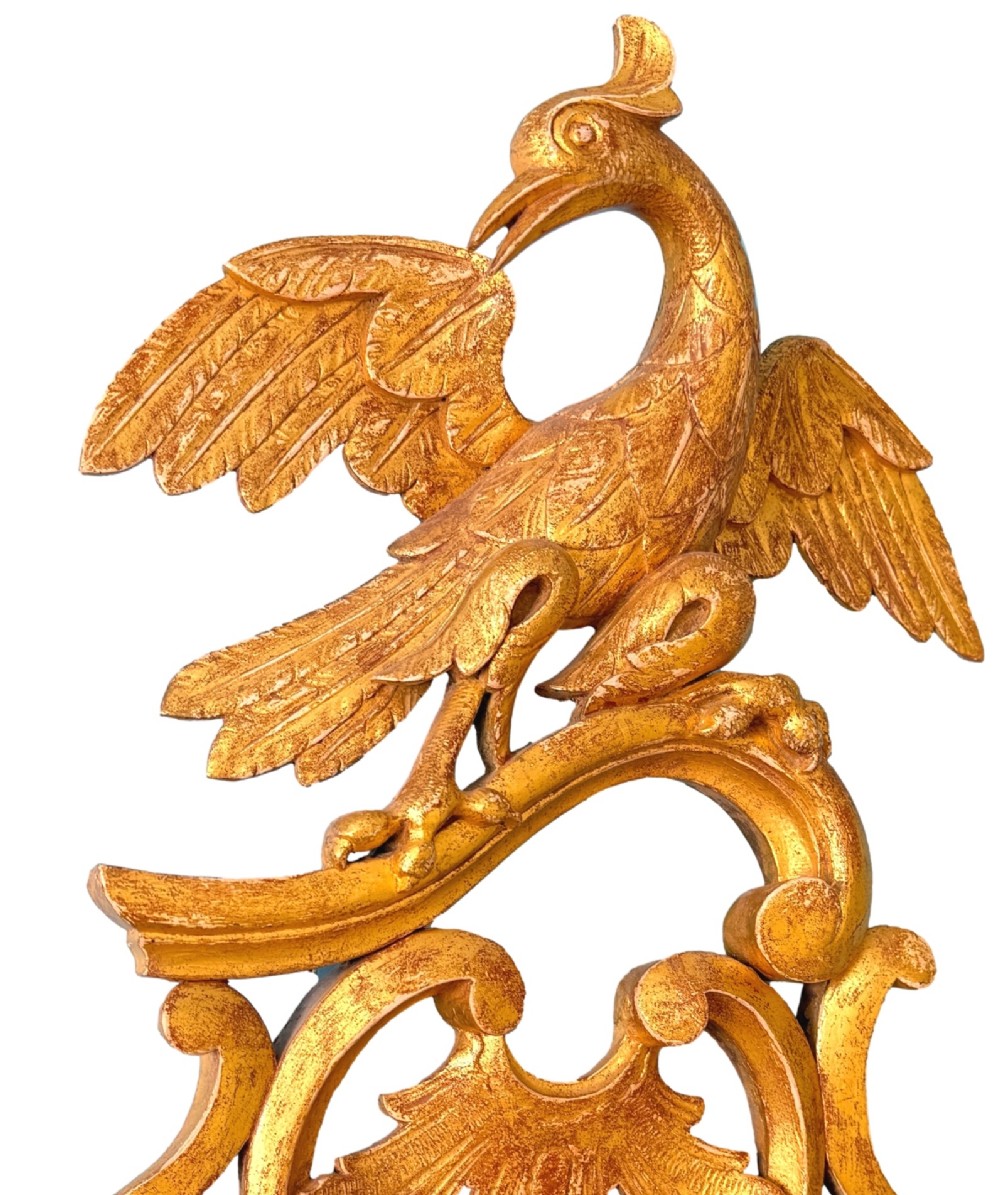 A pair of 18th-century Chippendale style giltwood wall mirrors featuring carved Rococo scroll frames topped with bird crests. View IX