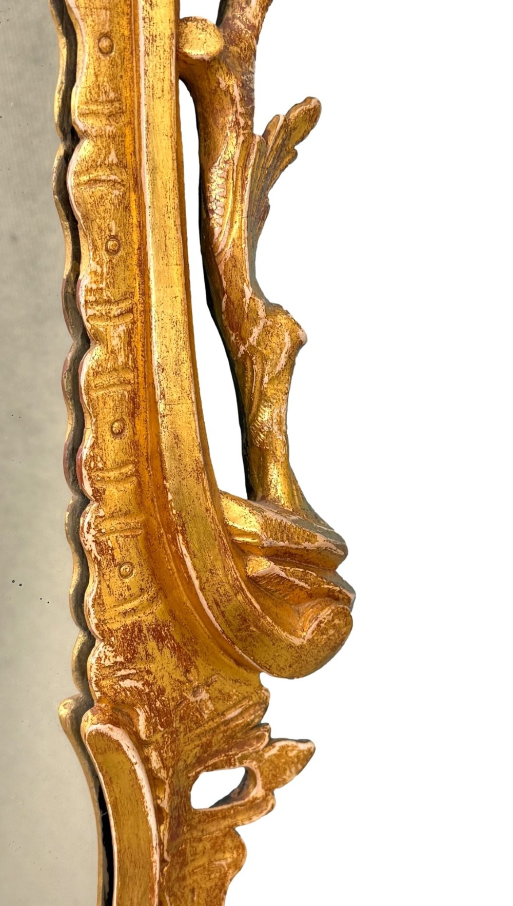 A pair of 18th-century Chippendale style giltwood wall mirrors featuring carved Rococo scroll frames topped with bird crests. View XI