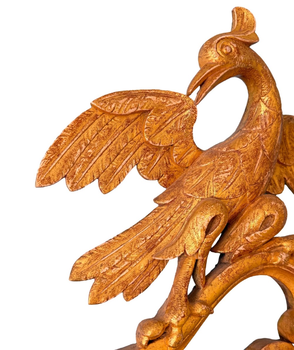 A pair of 18th-century Chippendale style giltwood wall mirrors featuring carved Rococo scroll frames topped with bird crests. View XII