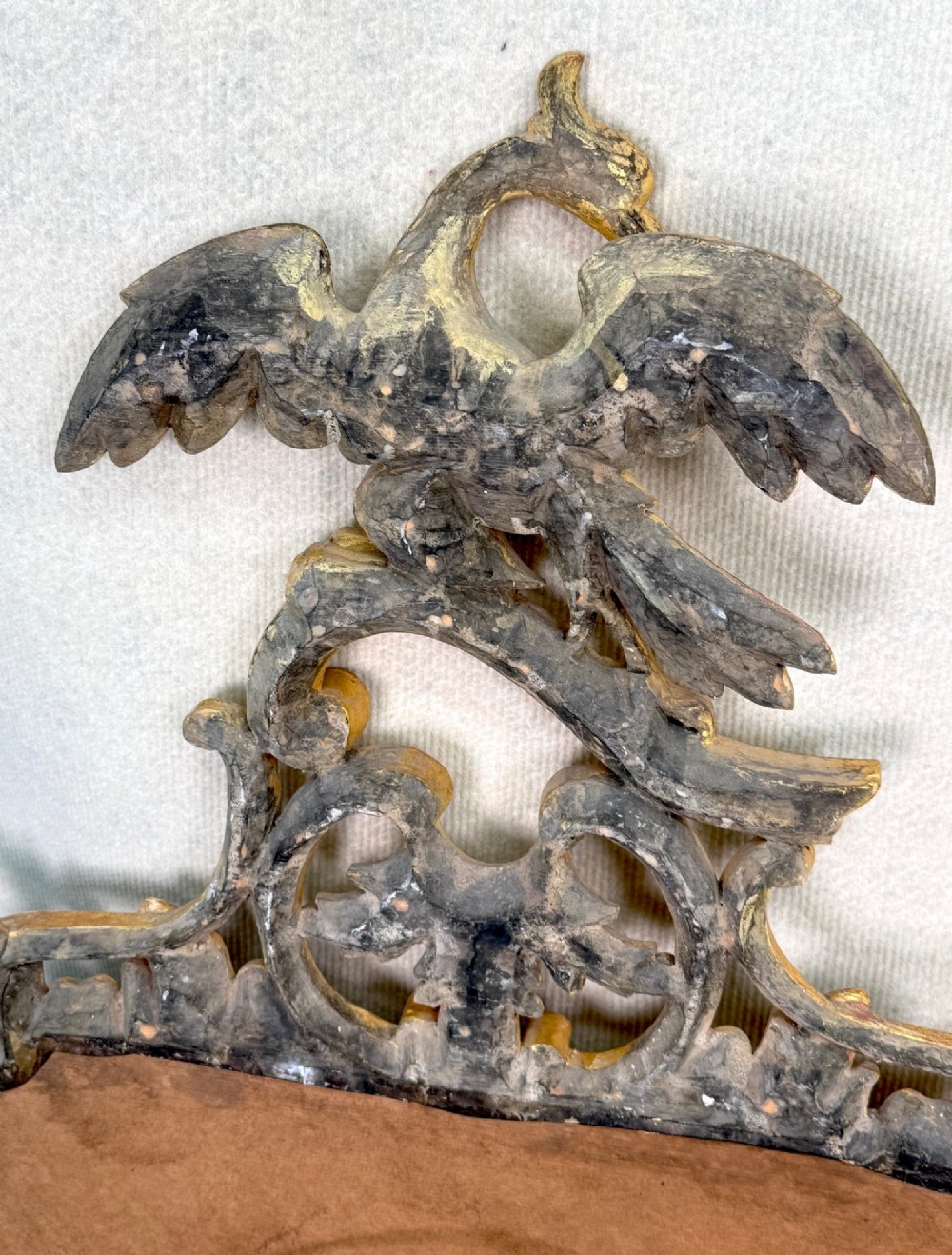 A pair of 18th-century Chippendale style giltwood wall mirrors featuring carved Rococo scroll frames topped with bird crests. View XIV