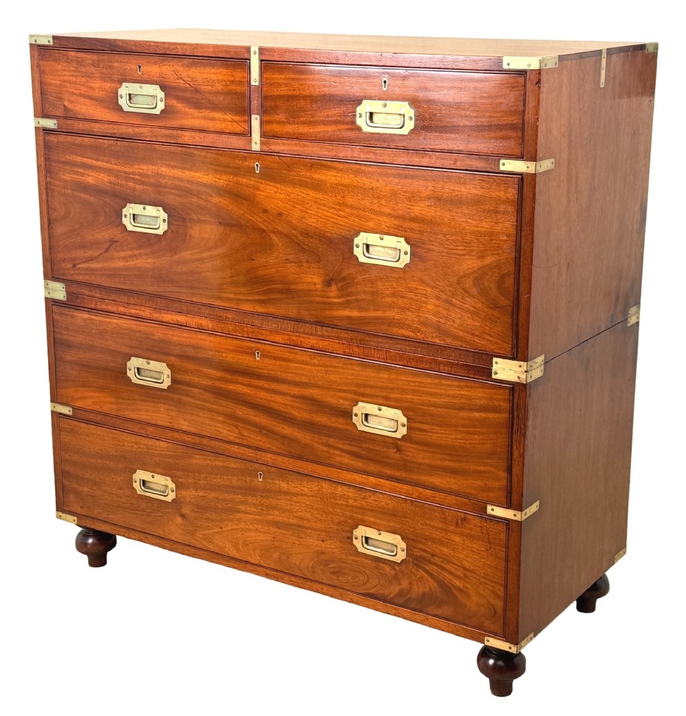A mid-19th century camphor wood military campaign chest of drawers featuring brass corner brackets, flush handles, and two separate stacking sections on turned feet.