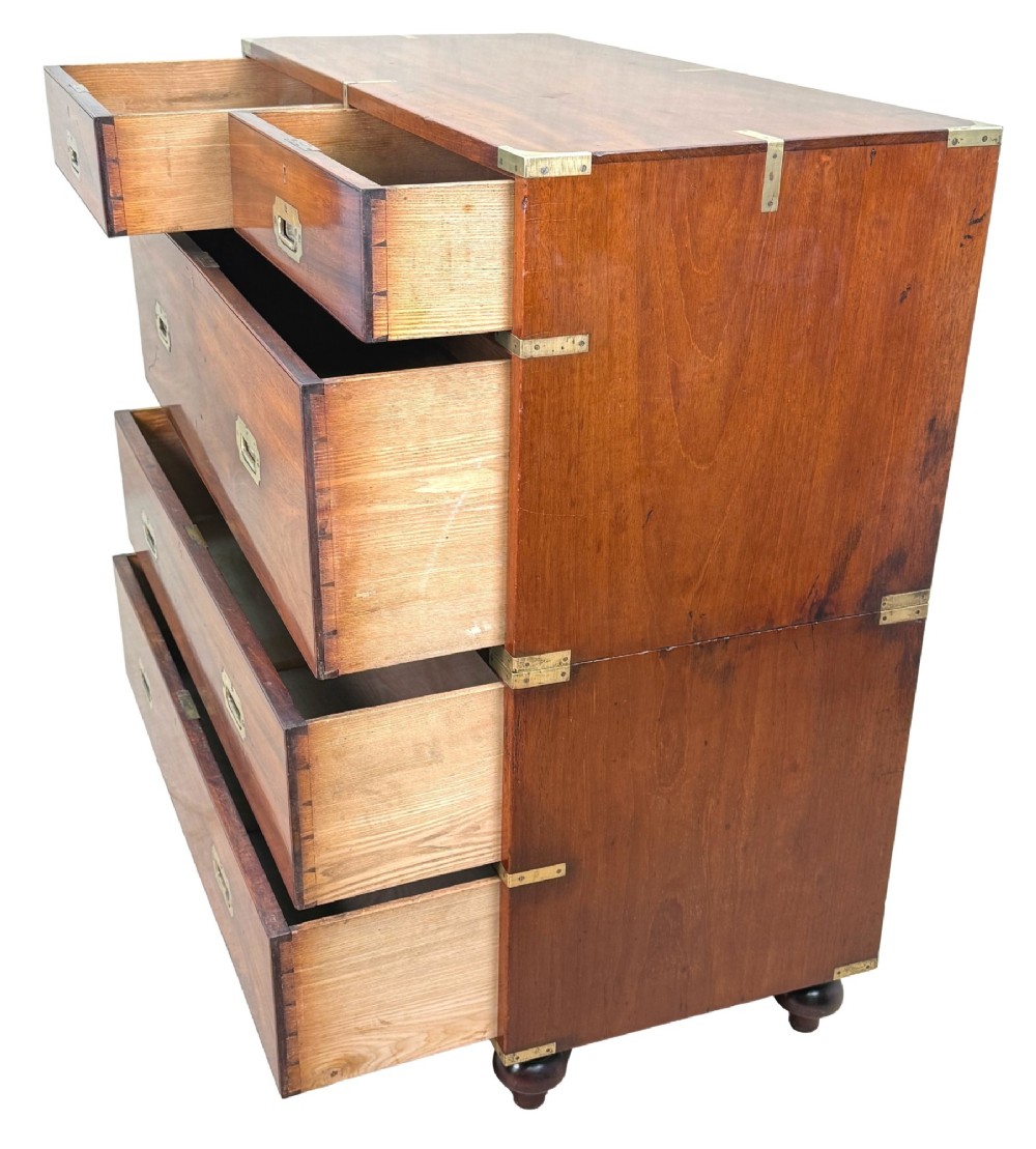 A mid-19th century camphor wood military campaign chest of drawers featuring brass corner brackets, flush handles, and two separate stacking sections on turned feet. View III