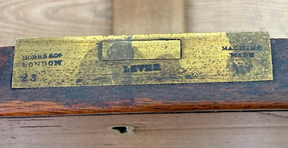 A mid-19th century camphor wood military campaign chest of drawers featuring brass corner brackets, flush handles, and two separate stacking sections on turned feet. View V