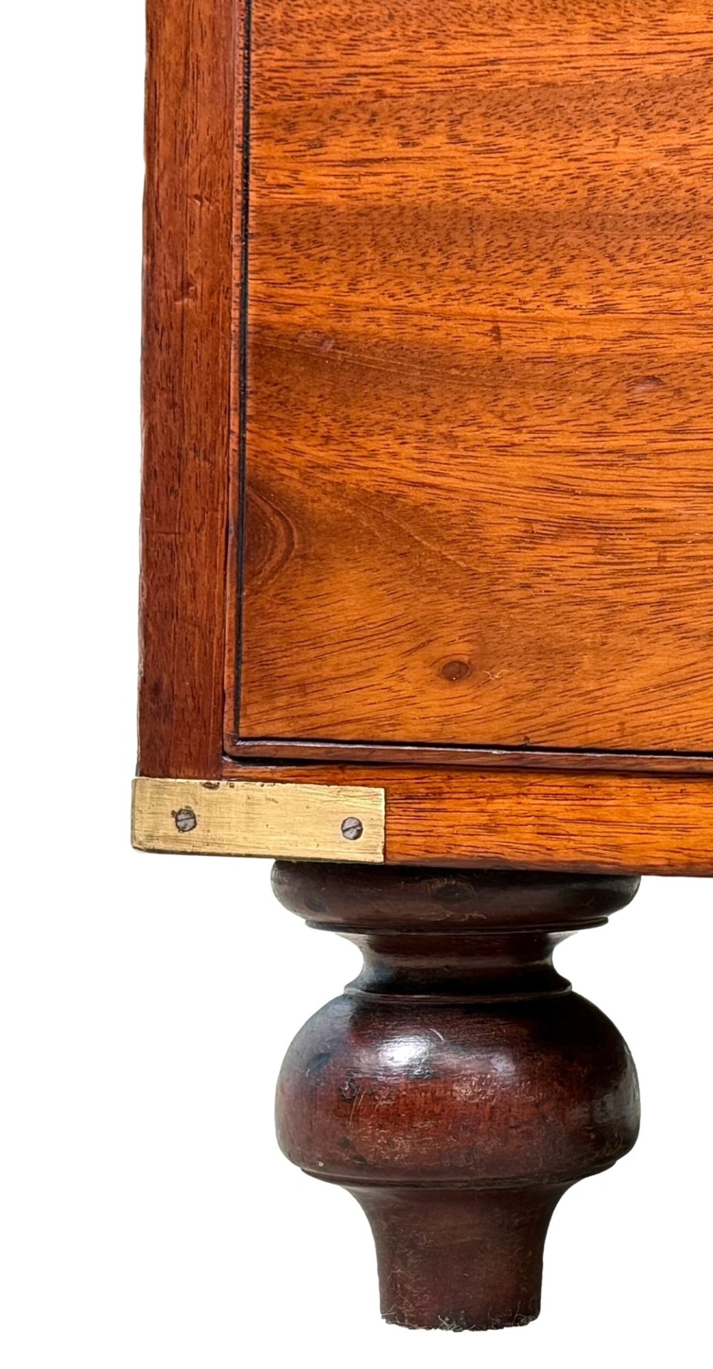 A mid-19th century camphor wood military campaign chest of drawers featuring brass corner brackets, flush handles, and two separate stacking sections on turned feet. View VI