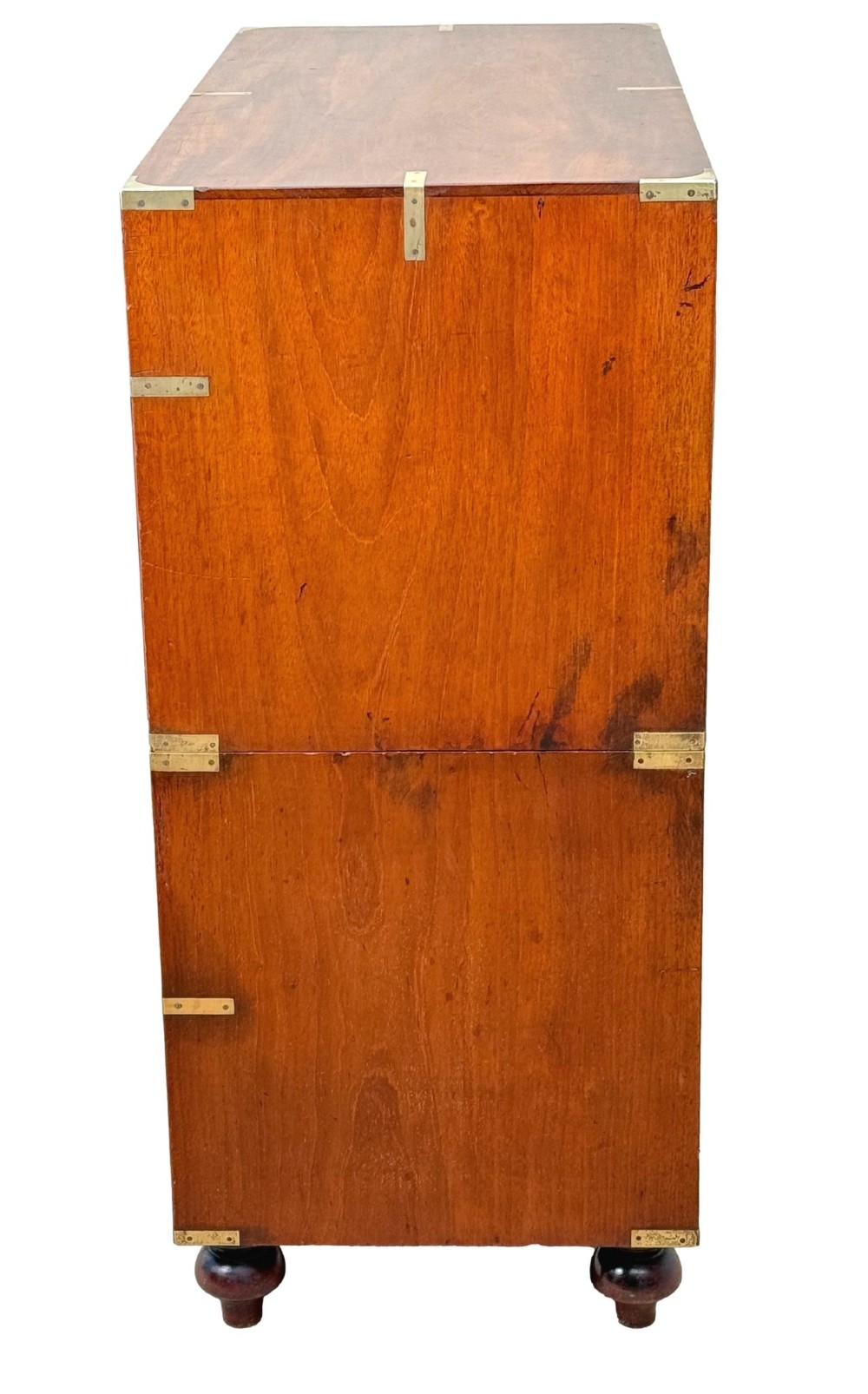 A mid-19th century camphor wood military campaign chest of drawers featuring brass corner brackets, flush handles, and two separate stacking sections on turned feet. View VII