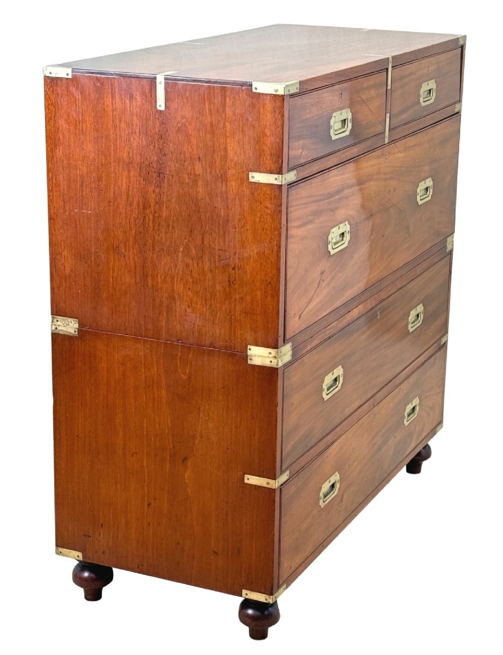 A mid-19th century camphor wood military campaign chest of drawers featuring brass corner brackets, flush handles, and two separate stacking sections on turned feet. View IX