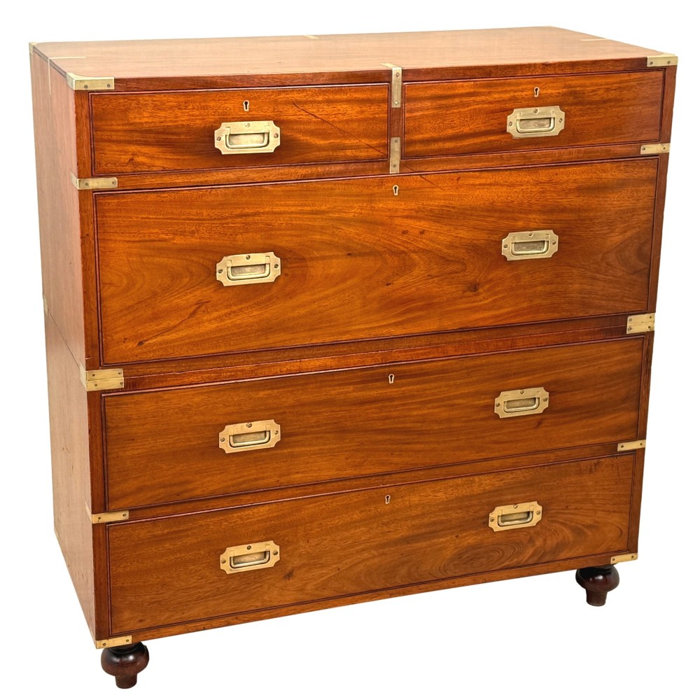 A mid-19th century camphor wood military campaign chest of drawers featuring brass corner brackets, flush handles, and two separate stacking sections on turned feet. View XI