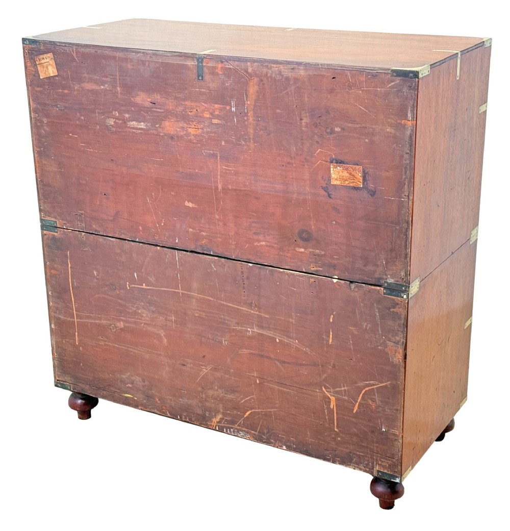 A mid-19th century camphor wood military campaign chest of drawers featuring brass corner brackets, flush handles, and two separate stacking sections on turned feet. View XII