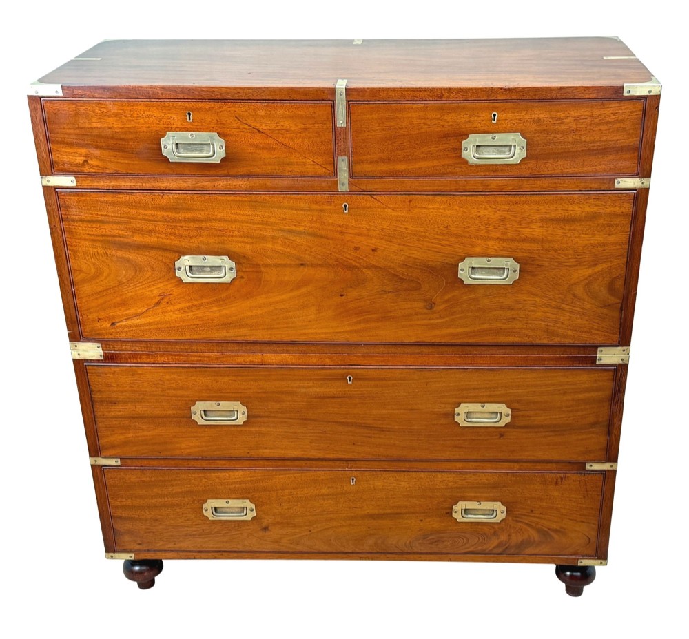 A mid-19th century camphor wood military campaign chest of drawers featuring brass corner brackets, flush handles, and two separate stacking sections on turned feet. View XV