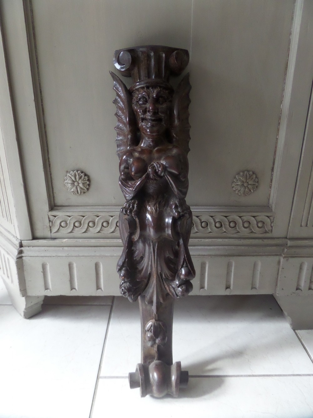 19TH CENTURY CARVED WALNUT WINGED MASKED MYTHICAL FIGURE