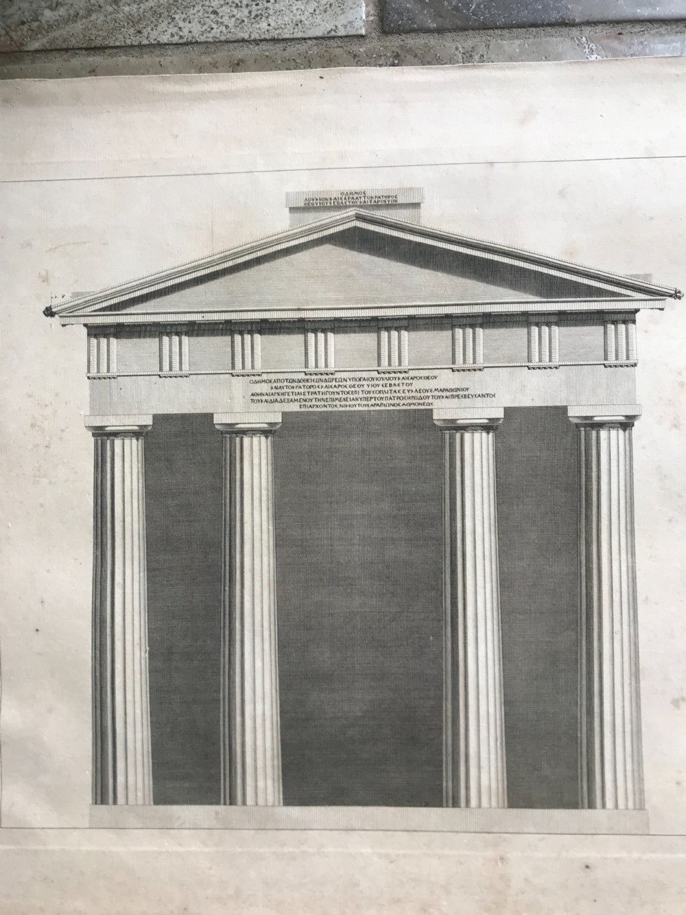 An eighteenth-century monochrome architectural engraving displaying the classical front elevation of the Doric Portico in Athens with Greek inscriptions.