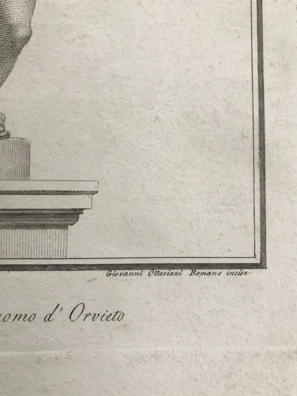 An 18th-century monochrome copperplate engraving depicting a classical draped statue of Saint Matthew holding a book alongside a winged cherub on a plinth. View III
