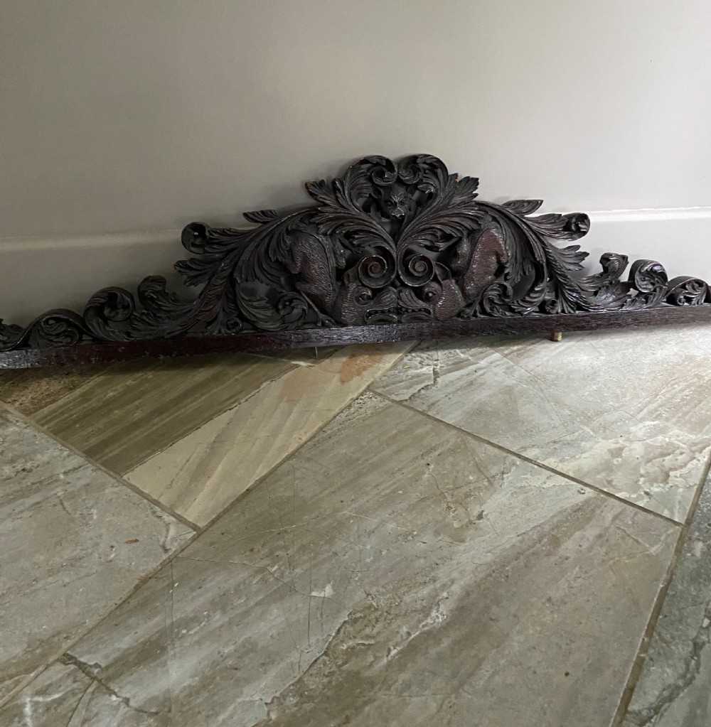 19TH CENTURY CARVED OAK MYTHICAL BEAST PEDIMENT PANEL