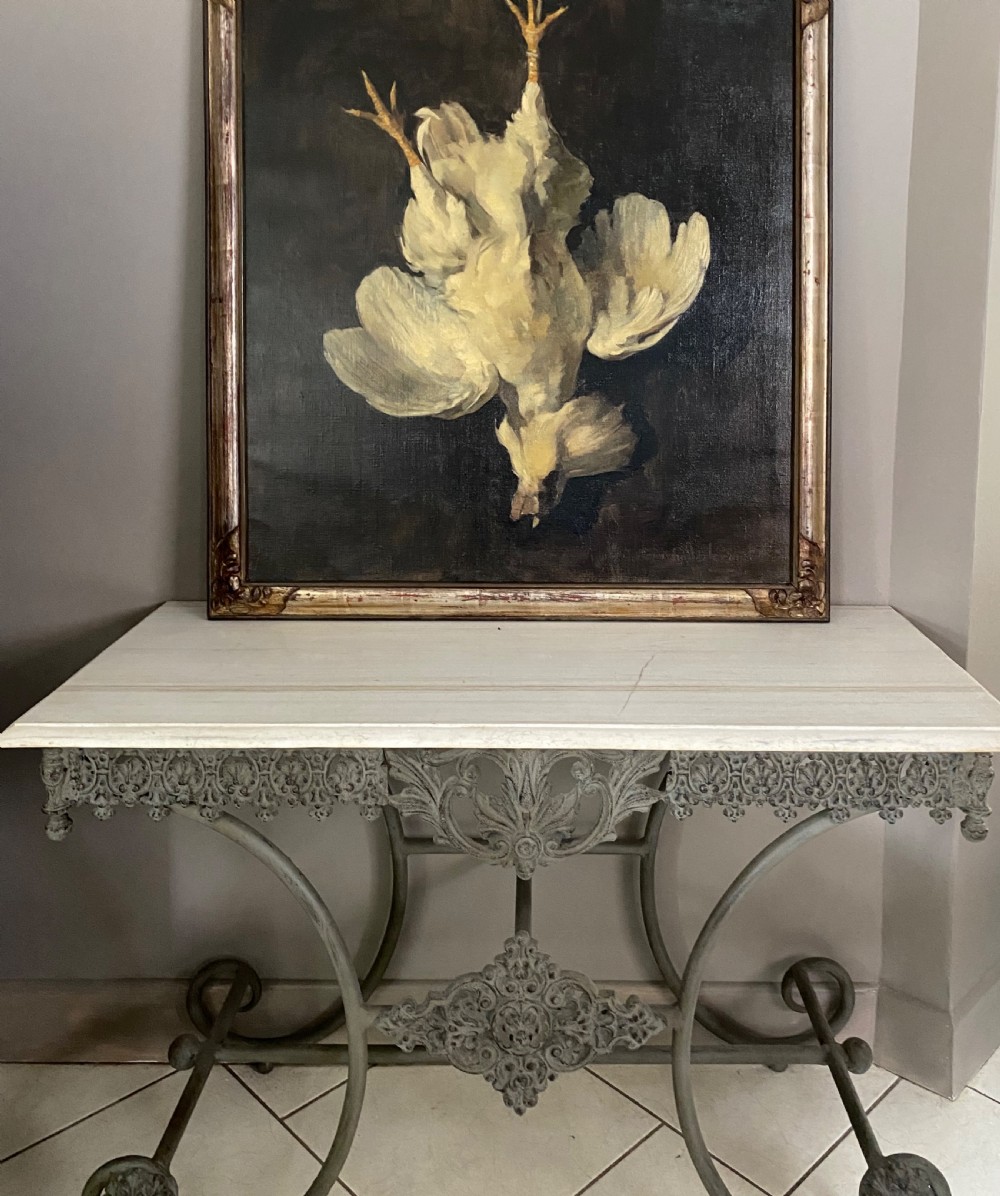 A large framed 19th-century oil painting on canvas depicting a suspended white cockerel against a dark background in a carved gilt frame. View III