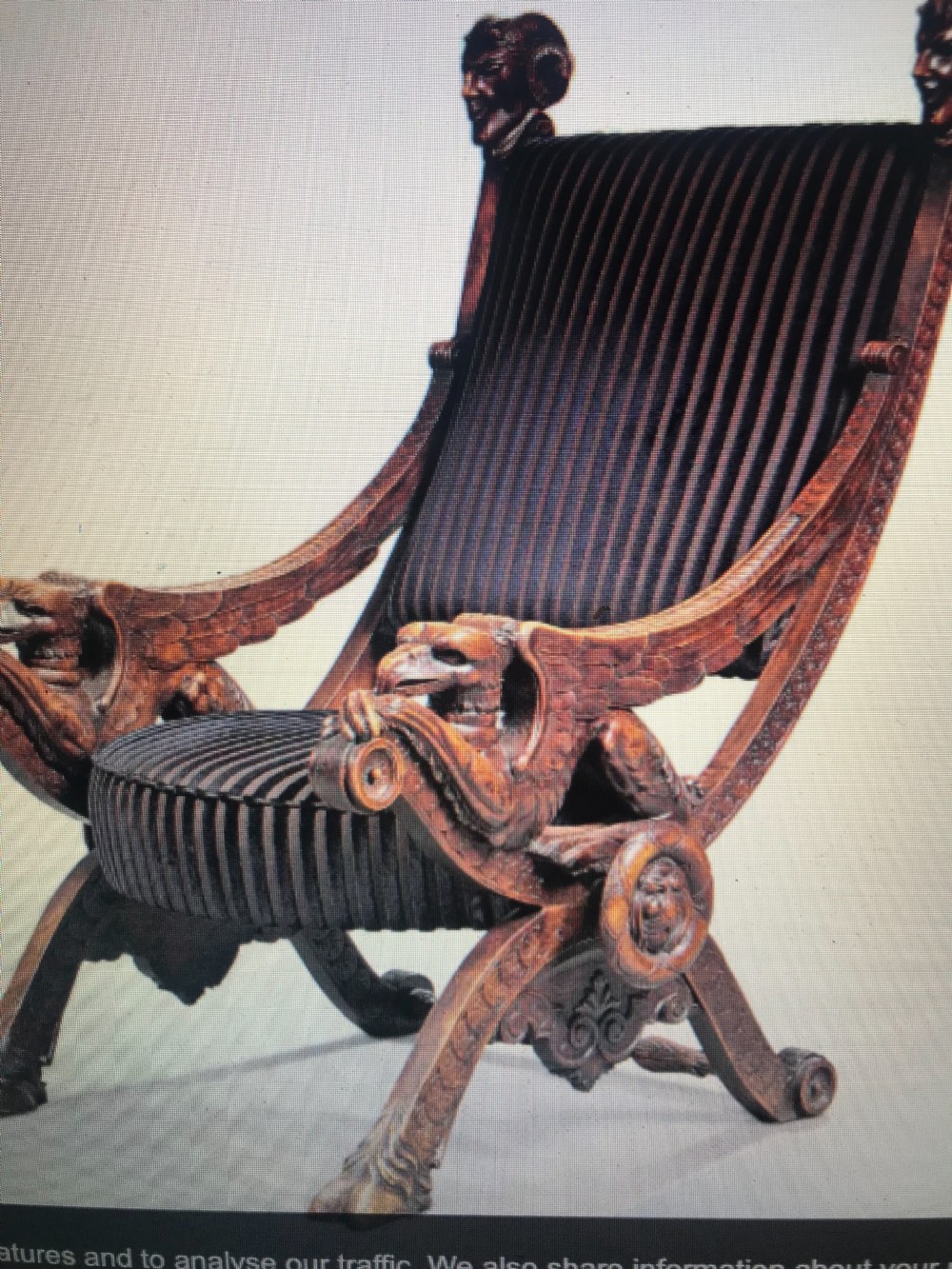 A pair of 19th-century carved walnut winged griffin sculptures mounted on slender dark metal display stands. View IV
