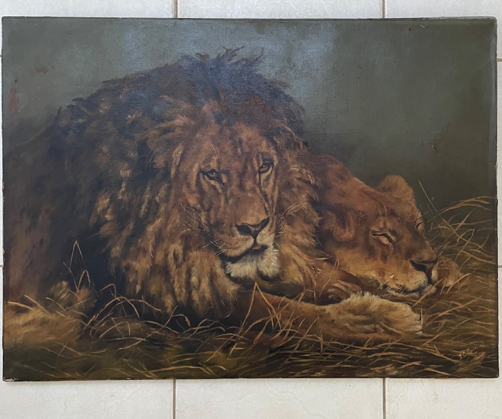 A 19th-century oil painting depicting a male lion and a lioness resting together on straw against a dark background.
