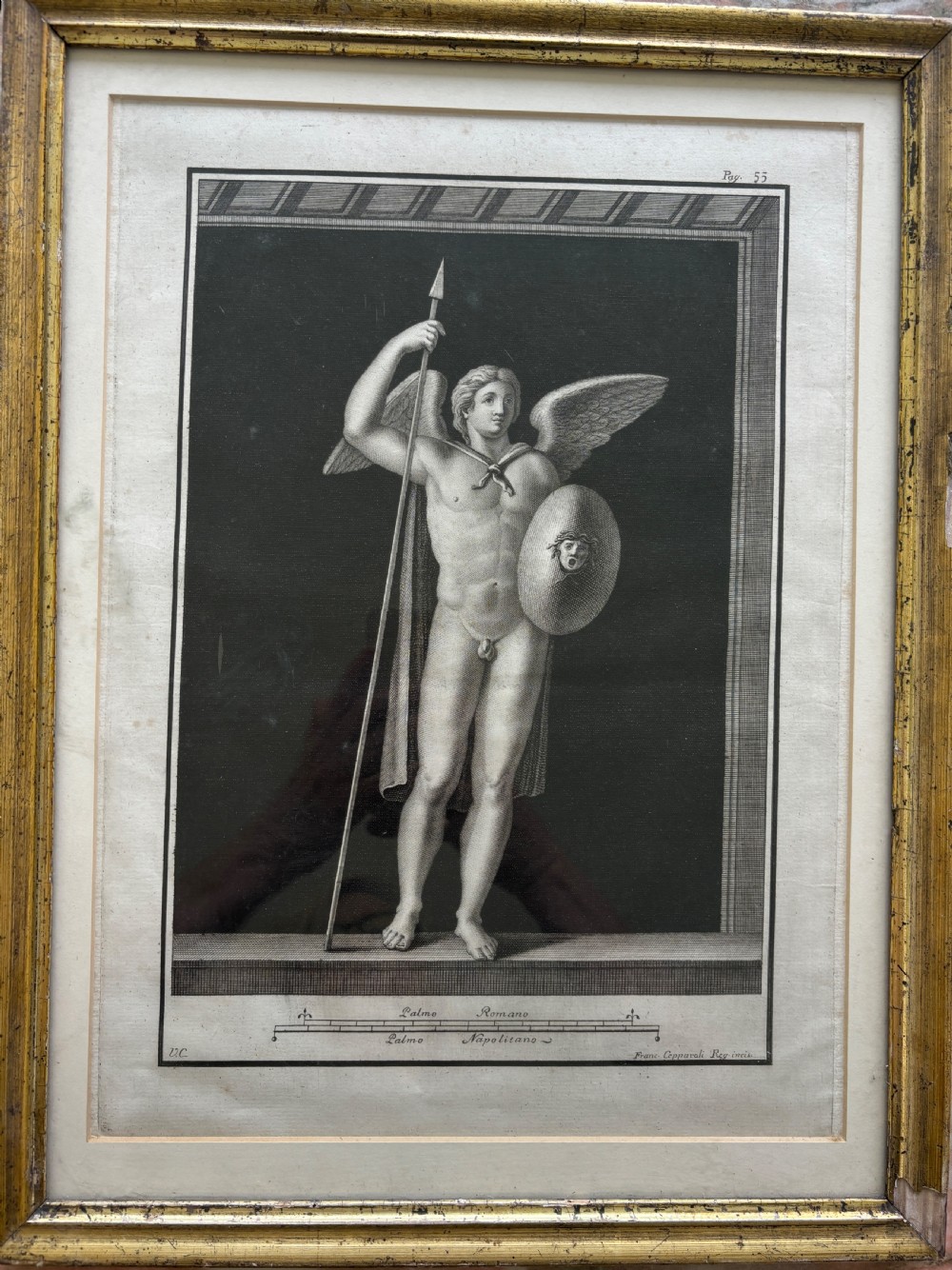 An 18th-century monochrome copperplate engraving depicting a classical winged mythological figure with a spear and shield, housed in a gilt wooden frame.
