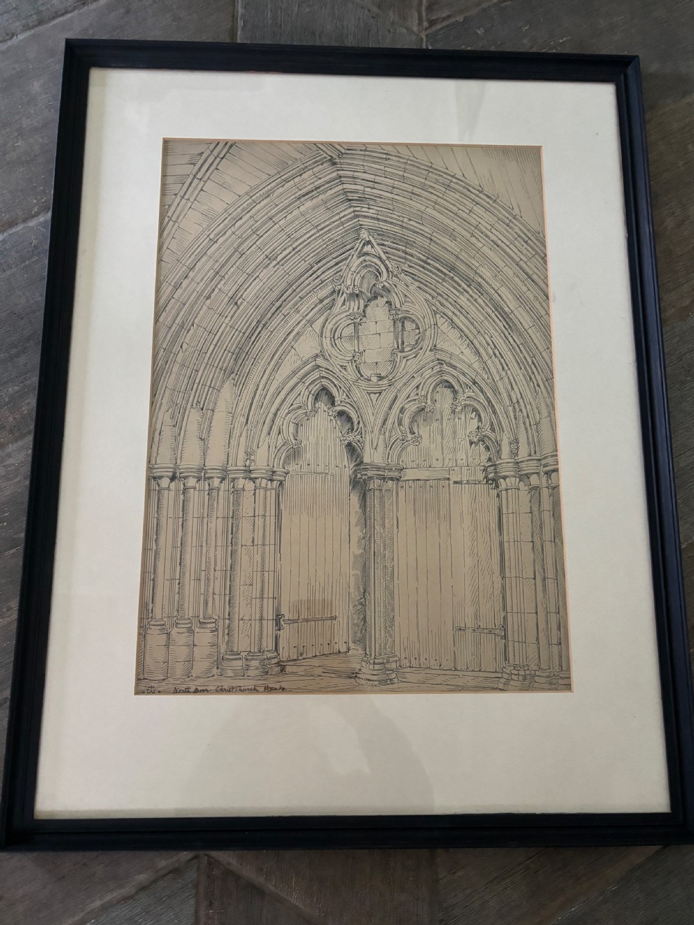 A framed 19th-century pen and ink architectural drawing depicting a detailed Gothic stone arched doorway with tracery and carved wooden doors.
