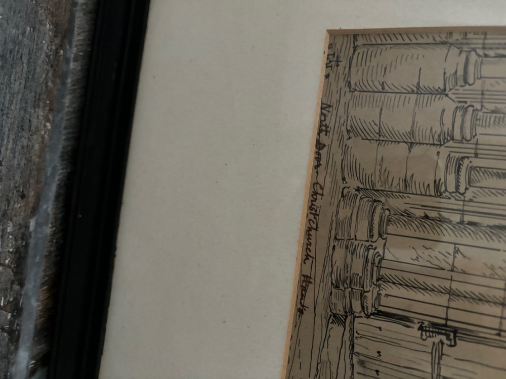 A framed 19th-century pen and ink architectural drawing depicting a detailed Gothic stone arched doorway with tracery and carved wooden doors. View III