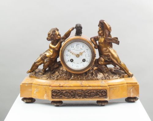 A Bronze and Sienna Marble French Mantel Clock.