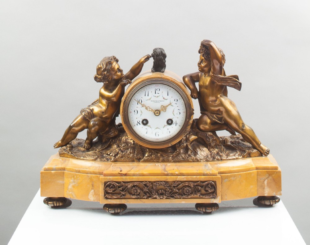 A Bronze and Sienna Marble French Mantel Clock.