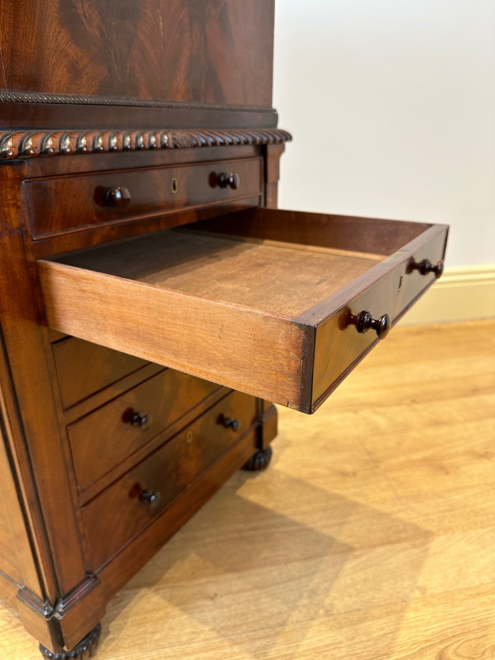 An antique Georgian mahogany Davenport desk featuring a sloped leather writing surface, decorative brass gallery, and side-mounted drawers. View IX
