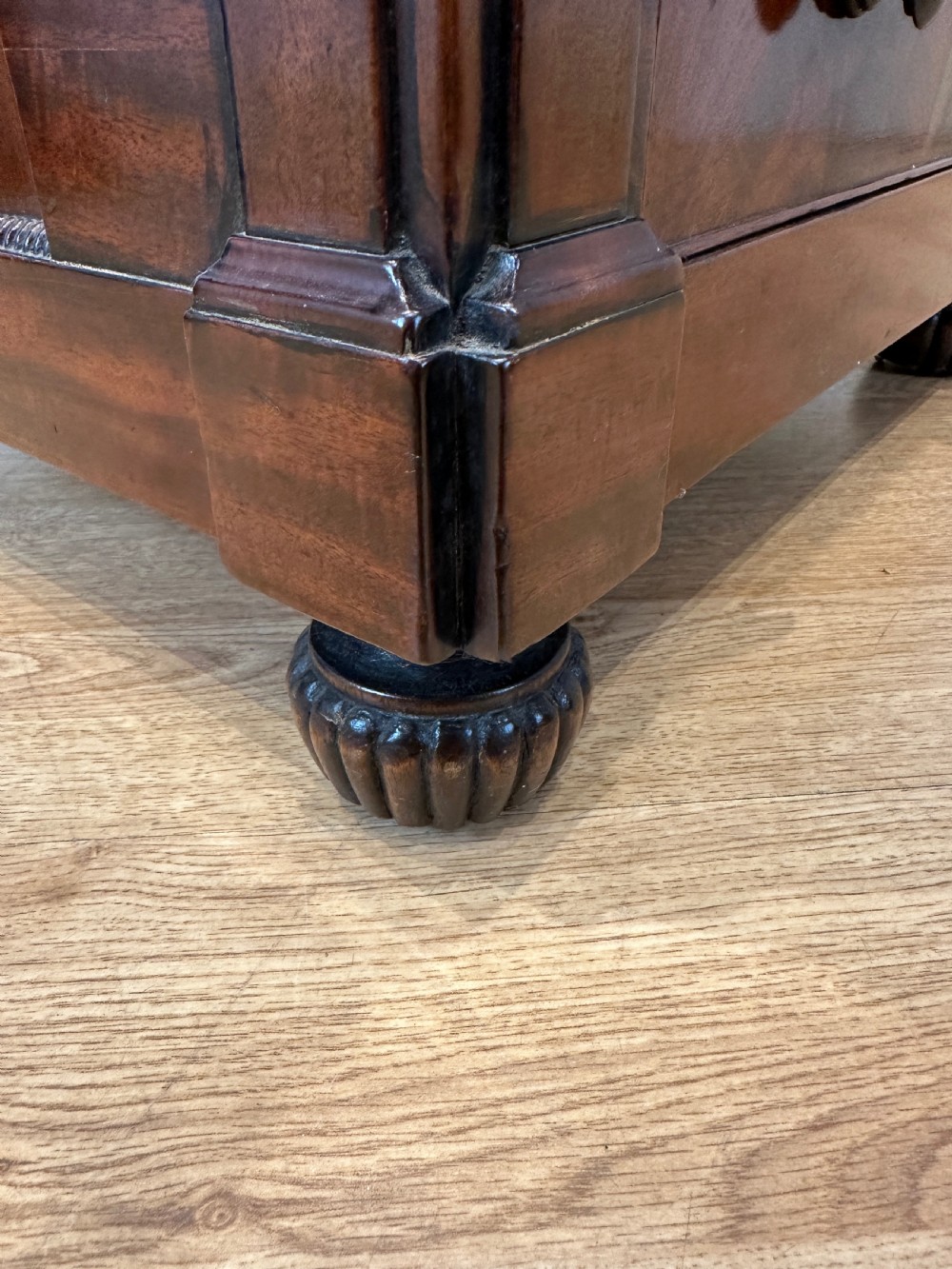An antique Georgian mahogany Davenport desk featuring a sloped leather writing surface, decorative brass gallery, and side-mounted drawers. View XI