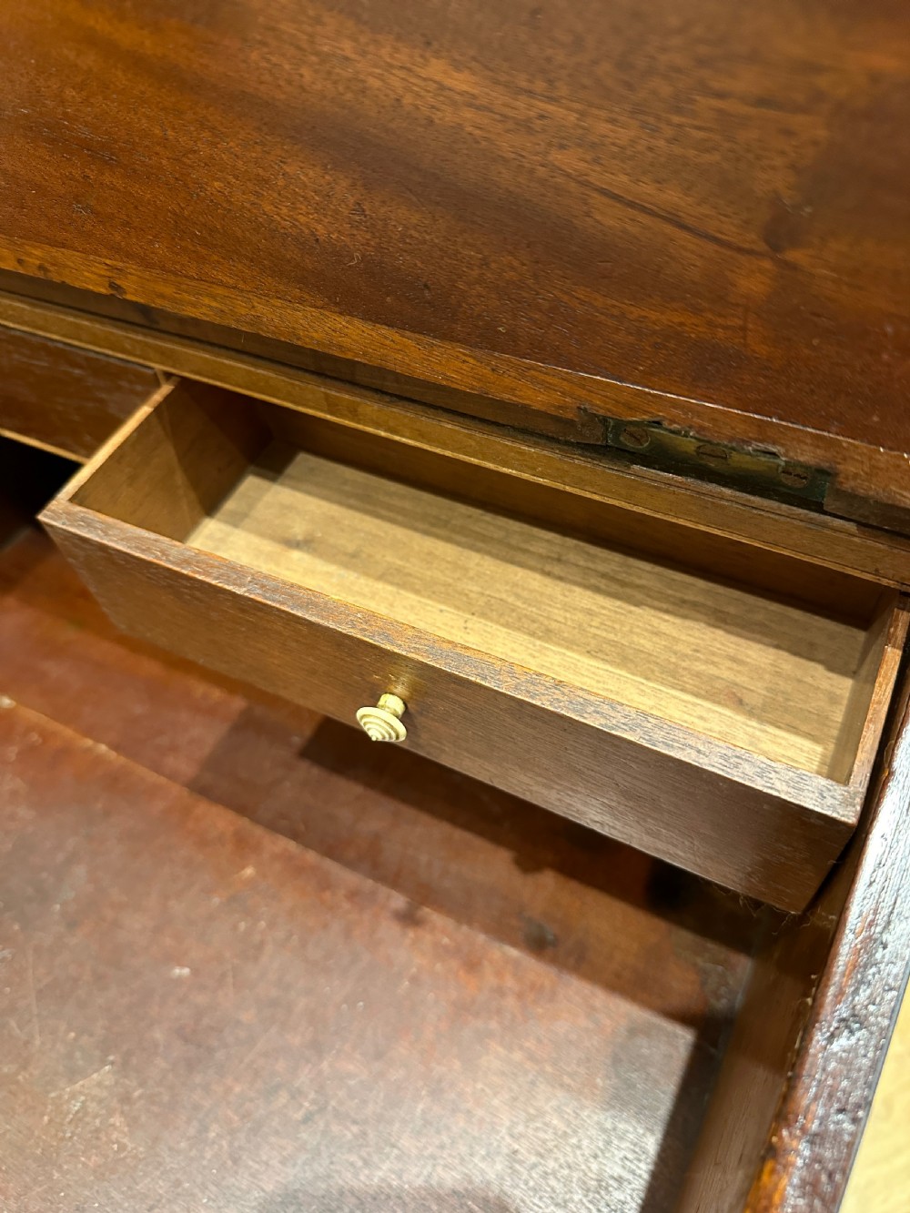 An antique Georgian mahogany Davenport desk featuring a sloped leather writing surface, decorative brass gallery, and side-mounted drawers. View XIV