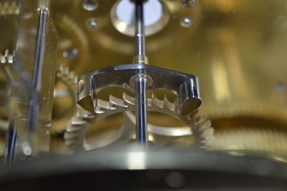 A Georgian mahogany bracket clock featuring a top brass pineapple finial, brass side handles, brass feet, and a arched dial signed John Agar Malton with a strike silent indicator. View XIV