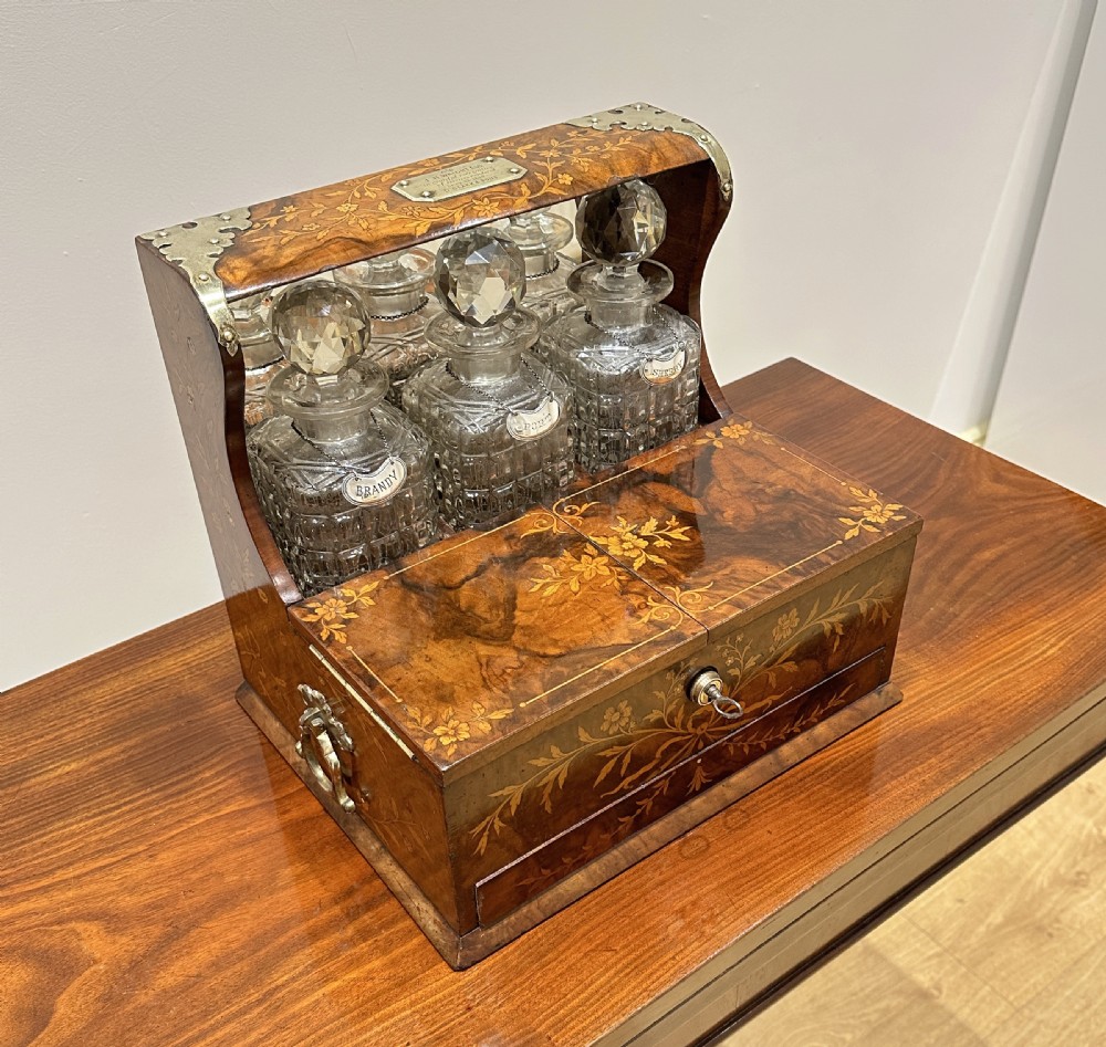 A Fine Quality Inlaid Walnut Three Decanter Tantalus & Games Box.